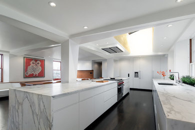 Inspiration for a large contemporary galley dark wood floor eat-in kitchen remodel in Boston with an undermount sink, flat-panel cabinets, white cabinets, an island, marble countertops and white appliances