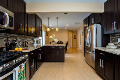 This is an example of a medium sized contemporary galley kitchen pantry in DC Metro with shaker cabinets, dark wood cabinets, granite worktops, multi-coloured splashback, metro tiled splashback, integrated appliances, no island, a submerged sink, porcelain flooring and beige floors.