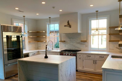 Eat-in kitchen - country u-shaped dark wood floor eat-in kitchen idea in Columbus with an undermount sink, beaded inset cabinets, white cabinets, marble countertops, white backsplash, marble backsplash, stainless steel appliances, an island and white countertops