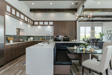 Eat-in kitchen - contemporary l-shaped multicolored floor eat-in kitchen idea in Tampa with an undermount sink, flat-panel cabinets, medium tone wood cabinets, quartz countertops, blue backsplash, glass tile backsplash, stainless steel appliances, an island and white countertops