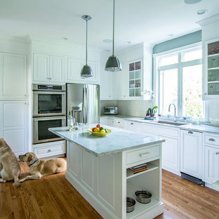 Inspiration for a mid-sized traditional u-shaped separate kitchen in Philadelphia with an undermount sink, beaded inset cabinets, white cabinets, quartzite benchtops, white splashback, ceramic splashback, stainless steel appliances, medium hardwood floors, with island, beige floor and green benchtop.