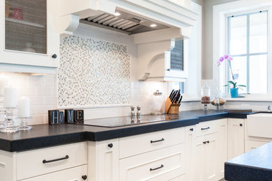 Example of a mid-sized u-shaped dark wood floor open concept kitchen design in Salt Lake City with a farmhouse sink, flat-panel cabinets, white cabinets, white backsplash, subway tile backsplash, paneled appliances and an island