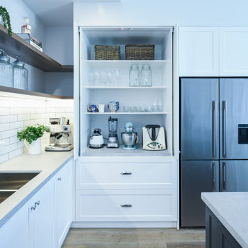 White appliance pantry with pocket doors