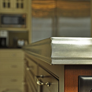 Mid-sized victorian u-shaped eat-in kitchen in Other with a farmhouse sink, shaker cabinets, white cabinets, zinc benchtops, white splashback, subway tile splashback, stainless steel appliances, ceramic floors and with island.
