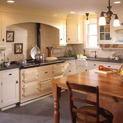 Kitchen - traditional kitchen idea in Seattle with subway tile backsplash, a farmhouse sink, wood countertops, beige backsplash and white appliances