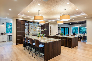 Inspiration for a contemporary u-shaped light wood floor and beige floor open concept kitchen remodel in Philadelphia with an undermount sink, flat-panel cabinets, dark wood cabinets, stainless steel appliances, two islands and beige countertops