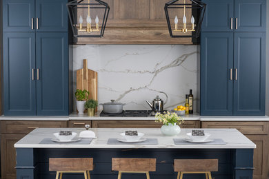 Photo of a traditional kitchen in San Francisco with blue cabinets, marble worktops, white splashback, marble splashback and white worktops.