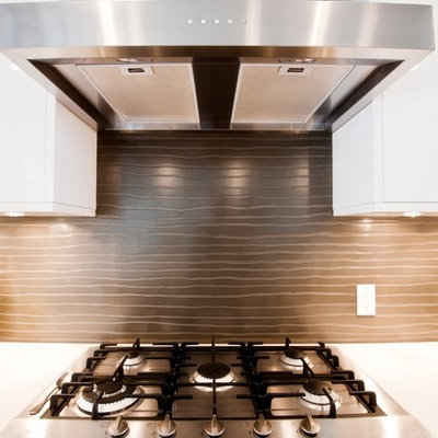 Example of a trendy kitchen design in Calgary with flat-panel cabinets, white cabinets and brown backsplash