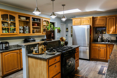 Example of a trendy kitchen design in Atlanta with granite countertops, metal backsplash, stainless steel appliances and an island