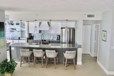 Eat-in kitchen - mid-sized contemporary galley porcelain tile and beige floor eat-in kitchen idea in Tampa with a farmhouse sink, shaker cabinets, gray cabinets, quartz countertops, metallic backsplash, glass tile backsplash, stainless steel appliances, no island and gray countertops