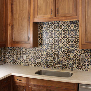 Design ideas for a mediterranean l-shaped eat-in kitchen in Dallas with an undermount sink, recessed-panel cabinets, medium wood cabinets, limestone benchtops, stone tile splashback, stainless steel appliances, travertine floors and with island.