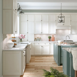 Design ideas for a medium sized traditional galley kitchen/diner in Other with an integrated sink, granite worktops, multi-coloured splashback, ceramic splashback, integrated appliances, light hardwood flooring, multiple islands, recessed-panel cabinets and beige floors.