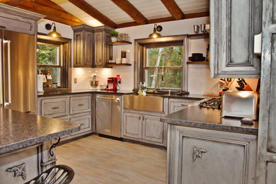 Mid-sized arts and crafts u-shaped light wood floor and white floor eat-in kitchen photo in Other with a farmhouse sink, gray cabinets, granite countertops, white backsplash, cement tile backsplash, stainless steel appliances, an island and recessed-panel cabinets