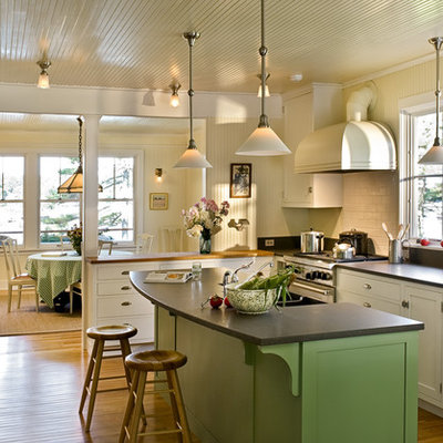 Enclosed kitchen - coastal l-shaped enclosed kitchen idea in Portland Maine with subway tile backsplash, stainless steel appliances, shaker cabinets, white cabinets, granite countertops and white backsplash