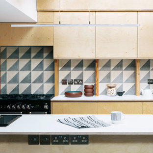 Photo of a small scandi single-wall kitchen in London with a double-bowl sink, flat-panel cabinets, light wood cabinets, cement tile splashback and an island.