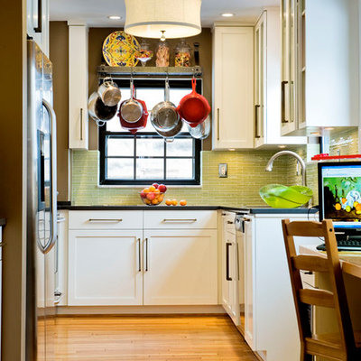 Eclectic u-shaped enclosed kitchen photo in Other with green backsplash, white cabinets, shaker cabinets, glass tile backsplash and stainless steel appliances
