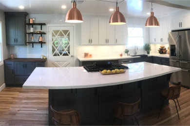 Kitchen - mid-sized transitional l-shaped medium tone wood floor and brown floor kitchen idea in Other with white backsplash, stainless steel appliances and an island