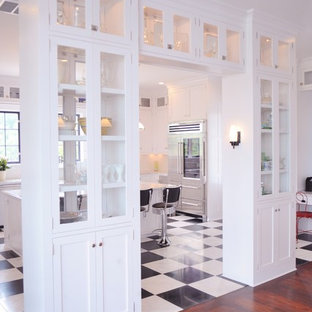 Design ideas for a large midcentury u-shaped open plan kitchen in Other with shaker cabinets, white cabinets, marble benchtops, stainless steel appliances, with island, white floor and marble floors.