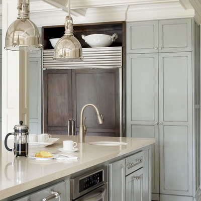 Mid-sized transitional u-shaped kitchen photo in Little Rock with stainless steel appliances, an undermount sink, recessed-panel cabinets, blue cabinets, quartz countertops, white backsplash, subway tile backsplash and an island