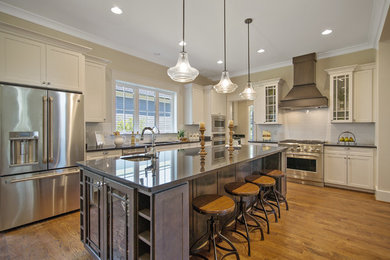 Open concept kitchen - large transitional l-shaped medium tone wood floor open concept kitchen idea in DC Metro with an undermount sink, recessed-panel cabinets, white cabinets, quartz countertops, stainless steel appliances and an island