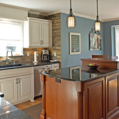 Inspiration for a timeless eat-in kitchen remodel in Detroit with a single-bowl sink, raised-panel cabinets, white cabinets, gray backsplash, stainless steel appliances and slate backsplash