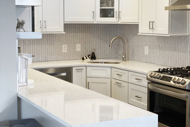 Example of a small transitional u-shaped open concept kitchen design in Other with an undermount sink, shaker cabinets, white cabinets, quartz countertops, white backsplash, mosaic tile backsplash, stainless steel appliances, a peninsula and white countertops