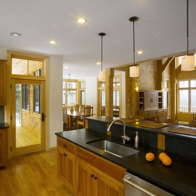 Open concept kitchen - large rustic u-shaped open concept kitchen idea in Burlington with an undermount sink, an island, recessed-panel cabinets, medium tone wood cabinets, gray backsplash and stainless steel appliances