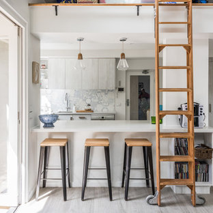 Mid-sized contemporary u-shaped kitchen in Melbourne with an undermount sink, flat-panel cabinets, quartz benchtops, blue splashback, mosaic tile splashback, stainless steel appliances, porcelain floors, white benchtop, a peninsula, grey cabinets and grey floor.