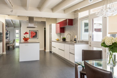Example of a mid-sized trendy u-shaped eat-in kitchen design in San Francisco with flat-panel cabinets, white cabinets, quartz countertops, multicolored backsplash, ceramic backsplash, an island and gray countertops
