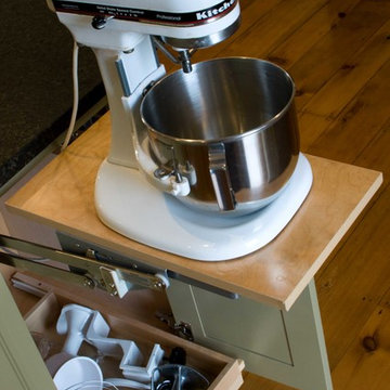 Pop-up mixer storage at the end of the island, with drawer below for storage.