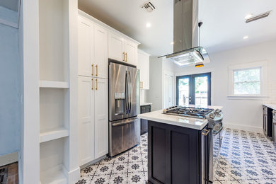 Inspiration for a mid-sized contemporary galley ceramic tile and multicolored floor enclosed kitchen remodel in Other with an undermount sink, shaker cabinets, white cabinets, solid surface countertops, white backsplash, subway tile backsplash, stainless steel appliances and an island