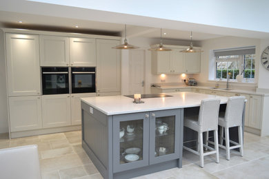 Inspiration for a large traditional l-shaped open plan kitchen in Other with a double-bowl sink, shaker cabinets, white cabinets, quartz worktops, stainless steel appliances, an island, white floors and white worktops.