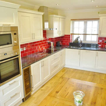 'Porcelain' painted timber shaker doors with beading.  Steel Grey granite tops