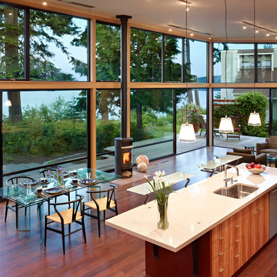 Example of a minimalist open concept kitchen design in Seattle with a single-bowl sink, flat-panel cabinets, medium tone wood cabinets, stainless steel appliances and quartz countertops