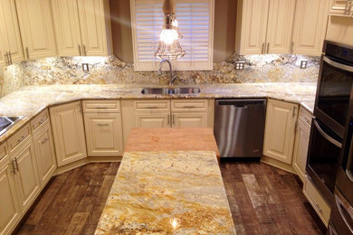 Large country u-shaped ceramic tile enclosed kitchen photo in DC Metro with an undermount sink, raised-panel cabinets, white cabinets, granite countertops, multicolored backsplash, stone slab backsplash, stainless steel appliances and an island