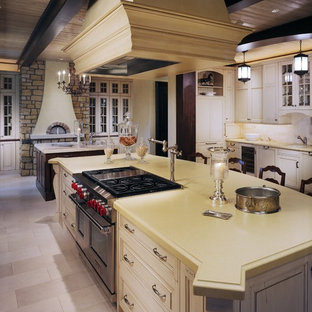 Example of a classic kitchen design in Denver with raised-panel cabinets, white cabinets and stainless steel appliances