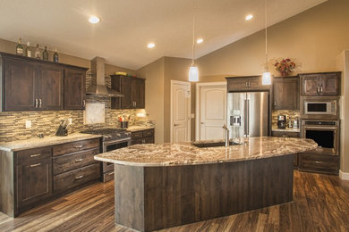 Large transitional l-shaped dark wood floor open concept kitchen photo in Wichita with an undermount sink, shaker cabinets, dark wood cabinets, granite countertops, multicolored backsplash, matchstick tile backsplash, stainless steel appliances and an island