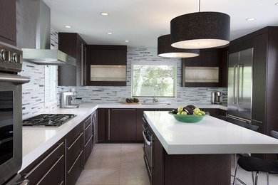 Example of a large trendy u-shaped porcelain tile and brown floor kitchen design in Phoenix with an undermount sink, flat-panel cabinets, dark wood cabinets, quartz countertops, gray backsplash, matchstick tile backsplash, stainless steel appliances and an island