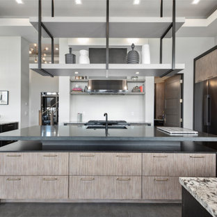 Large contemporary kitchen pantry designs - Inspiration for a large contemporary u-shaped concrete floor, gray floor and tray ceiling kitchen pantry remodel in Portland with a single-bowl sink, flat-panel cabinets, gray cabinets, limestone countertops, white backsplash, porcelain backsplash, black appliances, two islands and black countertops