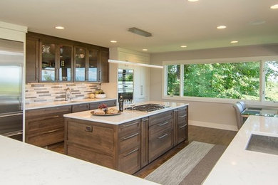 Eat-in kitchen - transitional medium tone wood floor eat-in kitchen idea in Portland with an undermount sink, shaker cabinets, white cabinets, quartz countertops, multicolored backsplash, glass tile backsplash, stainless steel appliances and an island
