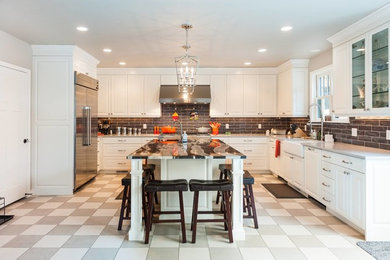 Transitional u-shaped white floor eat-in kitchen photo in Salt Lake City with an undermount sink, shaker cabinets, white cabinets, gray backsplash, subway tile backsplash, stainless steel appliances and an island