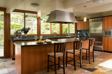 Example of a mid-sized transitional l-shaped kitchen design in San Francisco with an undermount sink, flat-panel cabinets, medium tone wood cabinets, blue backsplash, glass tile backsplash, stainless steel appliances and an island