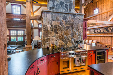 Example of a huge mountain style u-shaped light wood floor open concept kitchen design in Boston with recessed-panel cabinets, red cabinets, granite countertops, stainless steel appliances and an island
