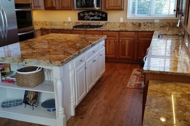 Elegant kitchen photo in Denver with granite countertops