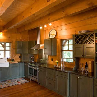 Inspiration for a mid-sized country l-shaped open plan kitchen in Charlotte with a drop-in sink, recessed-panel cabinets, green cabinets, granite benchtops, black splashback, stainless steel appliances, medium hardwood floors and no island.