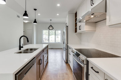 Example of a mid-sized minimalist single-wall beige floor eat-in kitchen design in Other with an undermount sink, shaker cabinets, quartz countertops, stainless steel appliances and an island