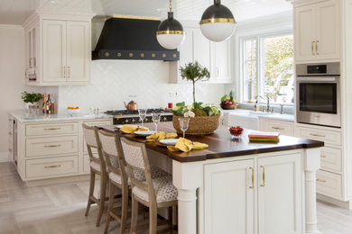 Kitchen - traditional l-shaped beige floor and shiplap ceiling kitchen idea in Philadelphia with a farmhouse sink, beaded inset cabinets, white cabinets, white backsplash, stainless steel appliances, an island and white countertops