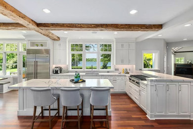 Kitchen - transitional kitchen idea in Minneapolis with white cabinets, stainless steel appliances and an island