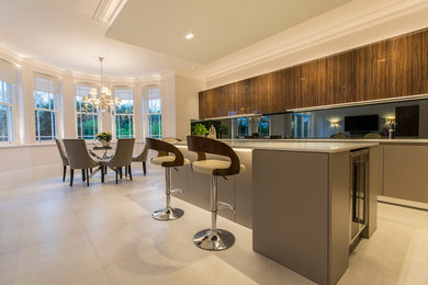 Inspiration for a large contemporary l-shaped kitchen/diner in Surrey with an island and white worktops.