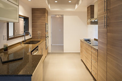 Design ideas for a medium sized contemporary galley kitchen pantry in Orange County with a single-bowl sink, flat-panel cabinets, medium wood cabinets, engineered stone countertops, brown splashback, stone slab splashback, stainless steel appliances, marble flooring and no island.